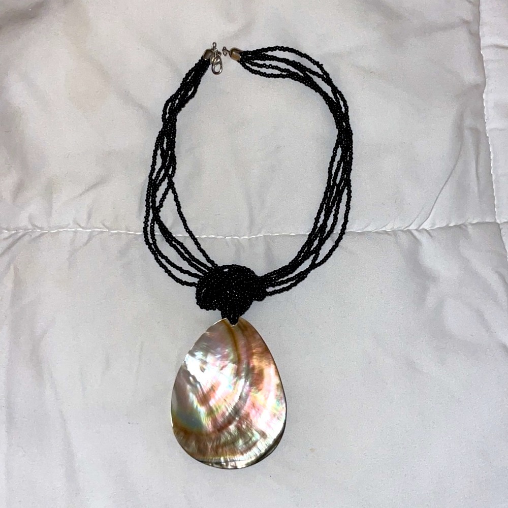 Large abalone shell on black beaded necklace is adjustable to choker if desired